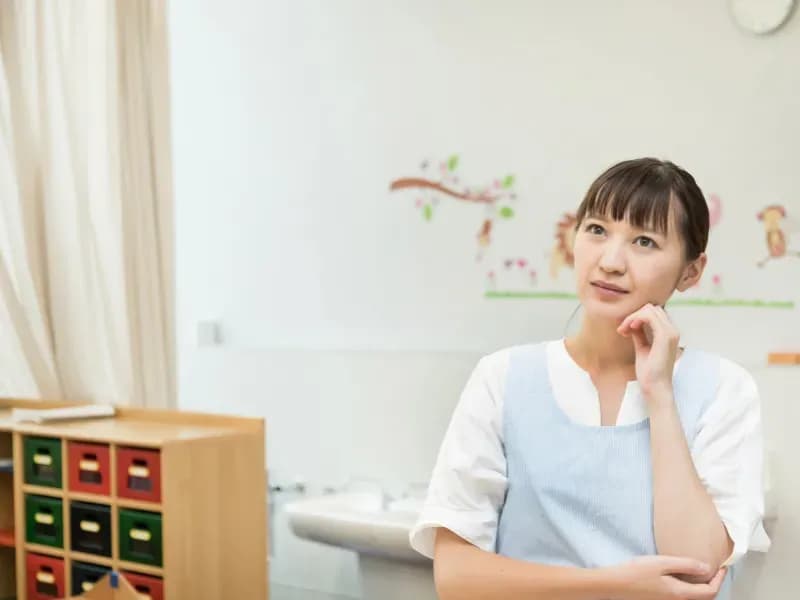 考える保育士の画像
